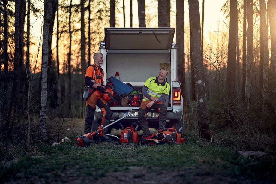 Loggers resting against truck with 560 XP 572 XP 545 brushcutter
