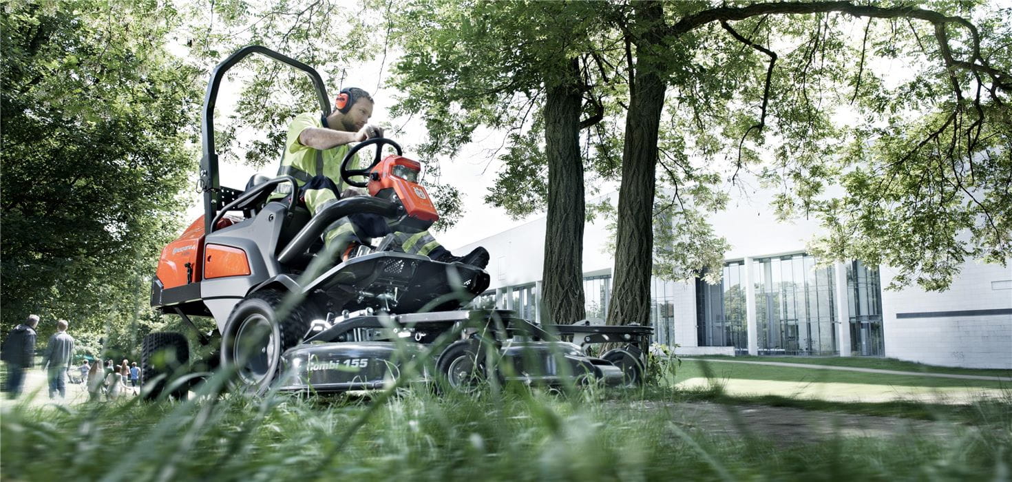 Man on a Husqvarna Front Mower in a park