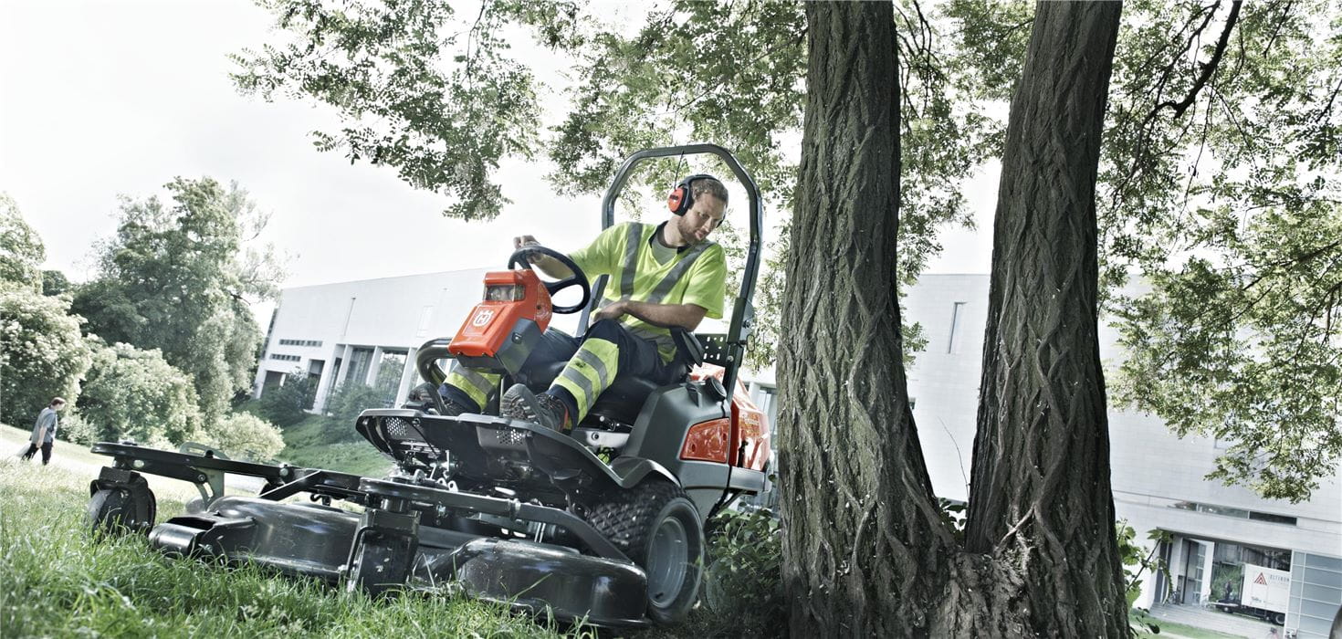 Man on a Husqvarna Front Mower in a park
