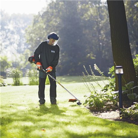 Trimming the lawn with a Husqvarna
