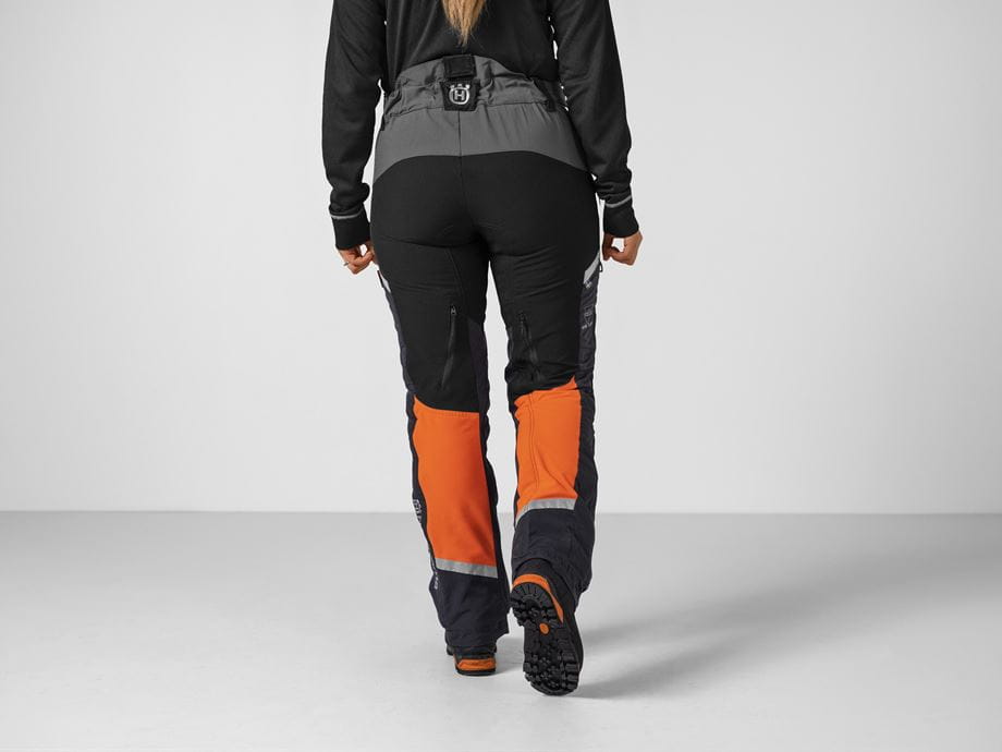 Technical Extreme Arborist trousers - female model, back (Studio background)