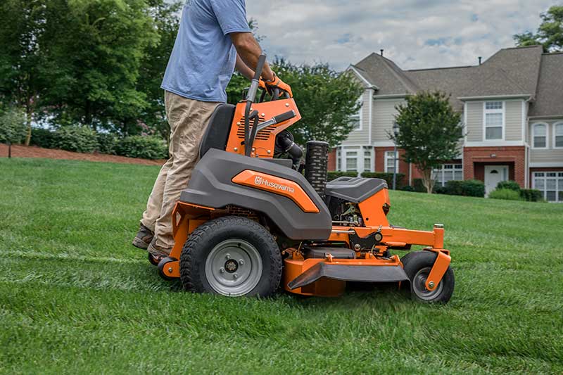 Husqvarna stand on mower sideview with driver