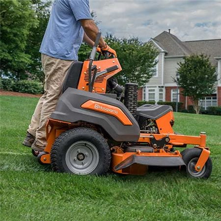 Husqvarna stand on mower sideview with driver
